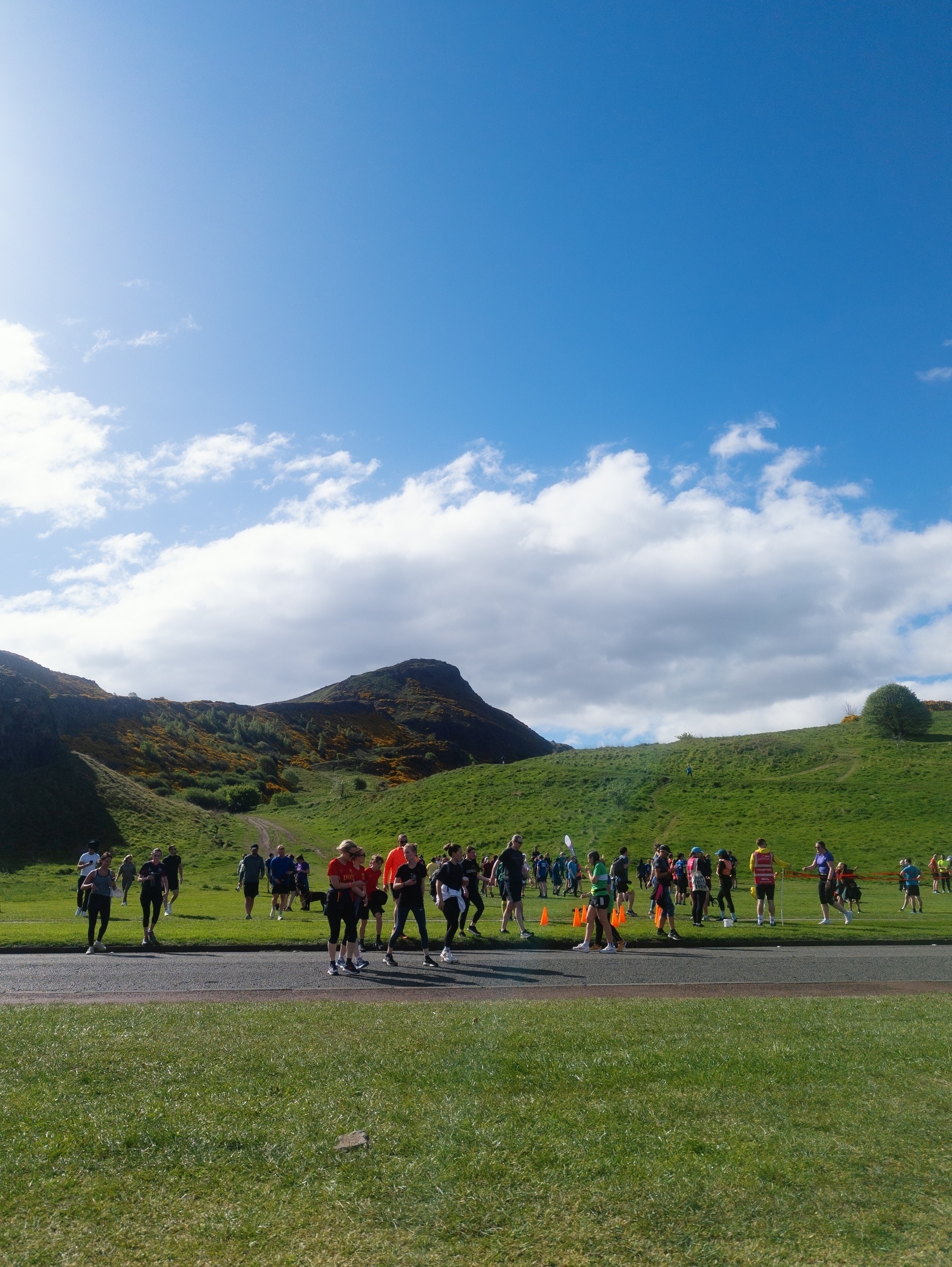 Runners at the finish of Parkrun in front of Arthur's Seat 