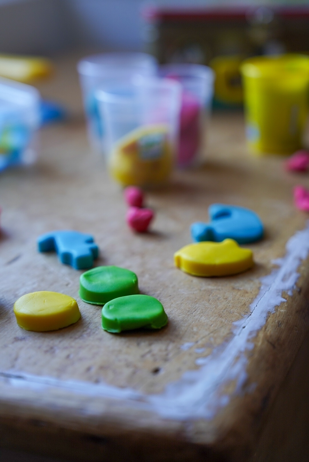 Colourful playdough shapes on a wooden chest