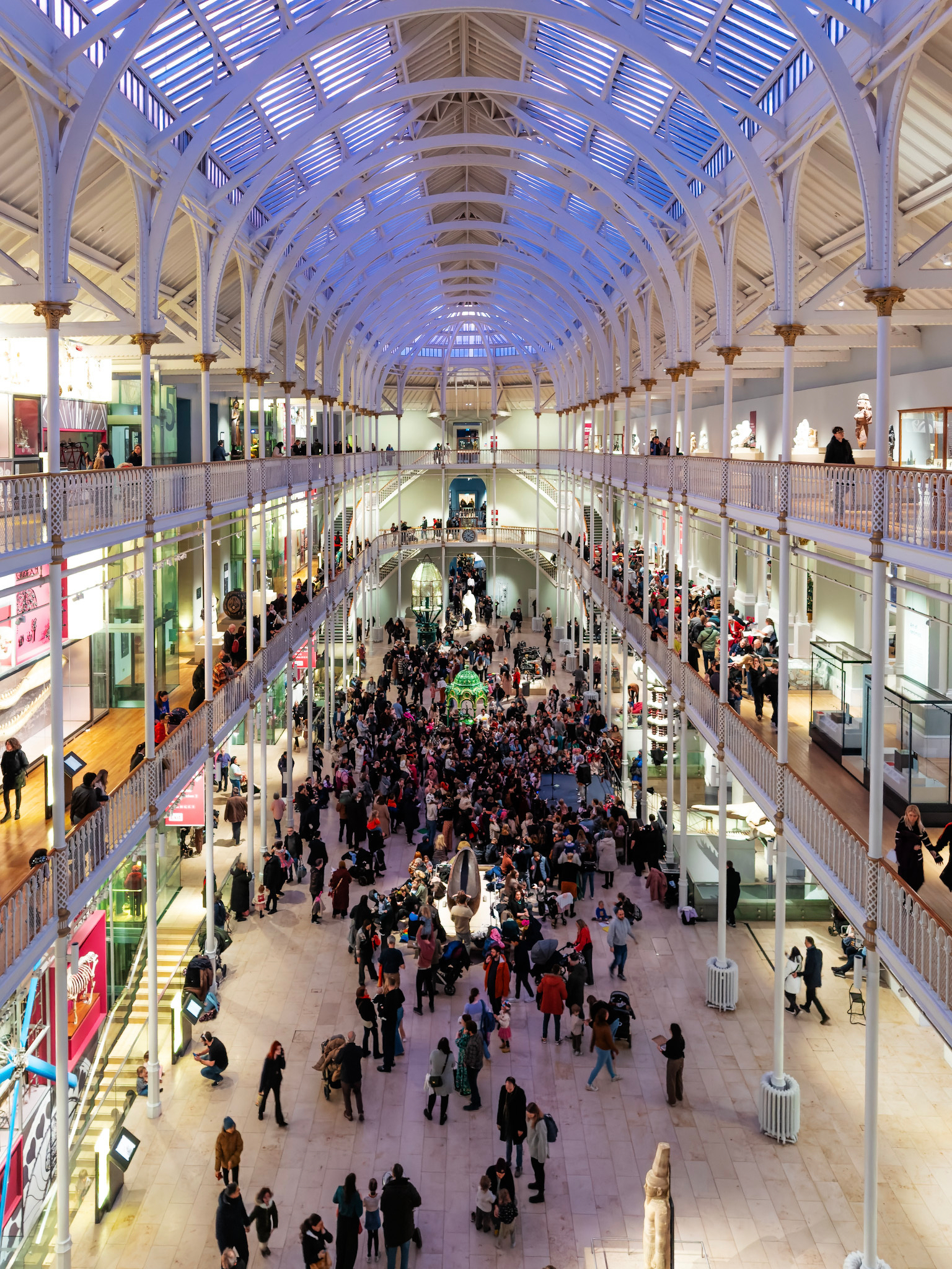 Main hall of the National museum with a crowd listening to performers